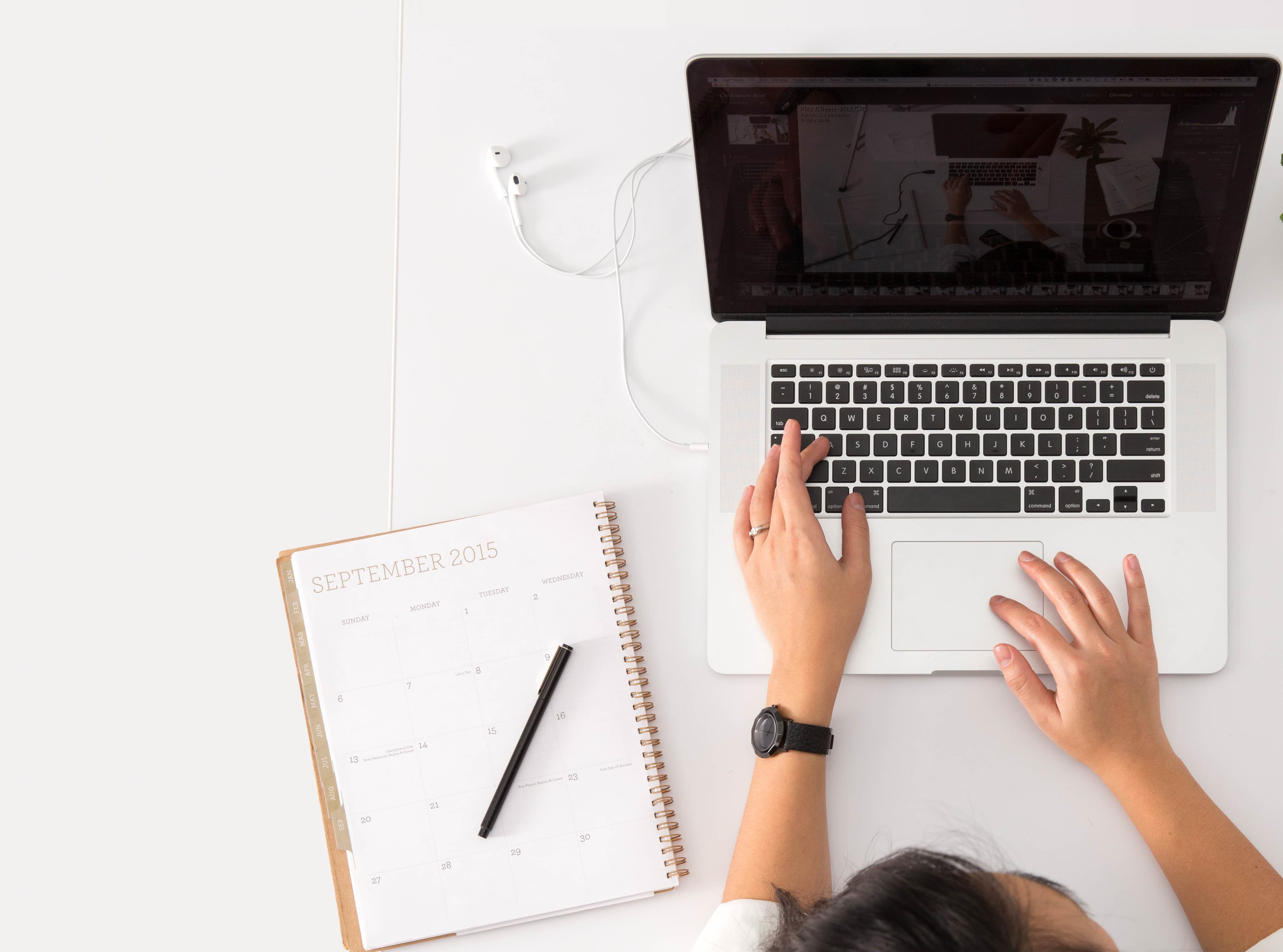 laptop with a hand on the keyboard