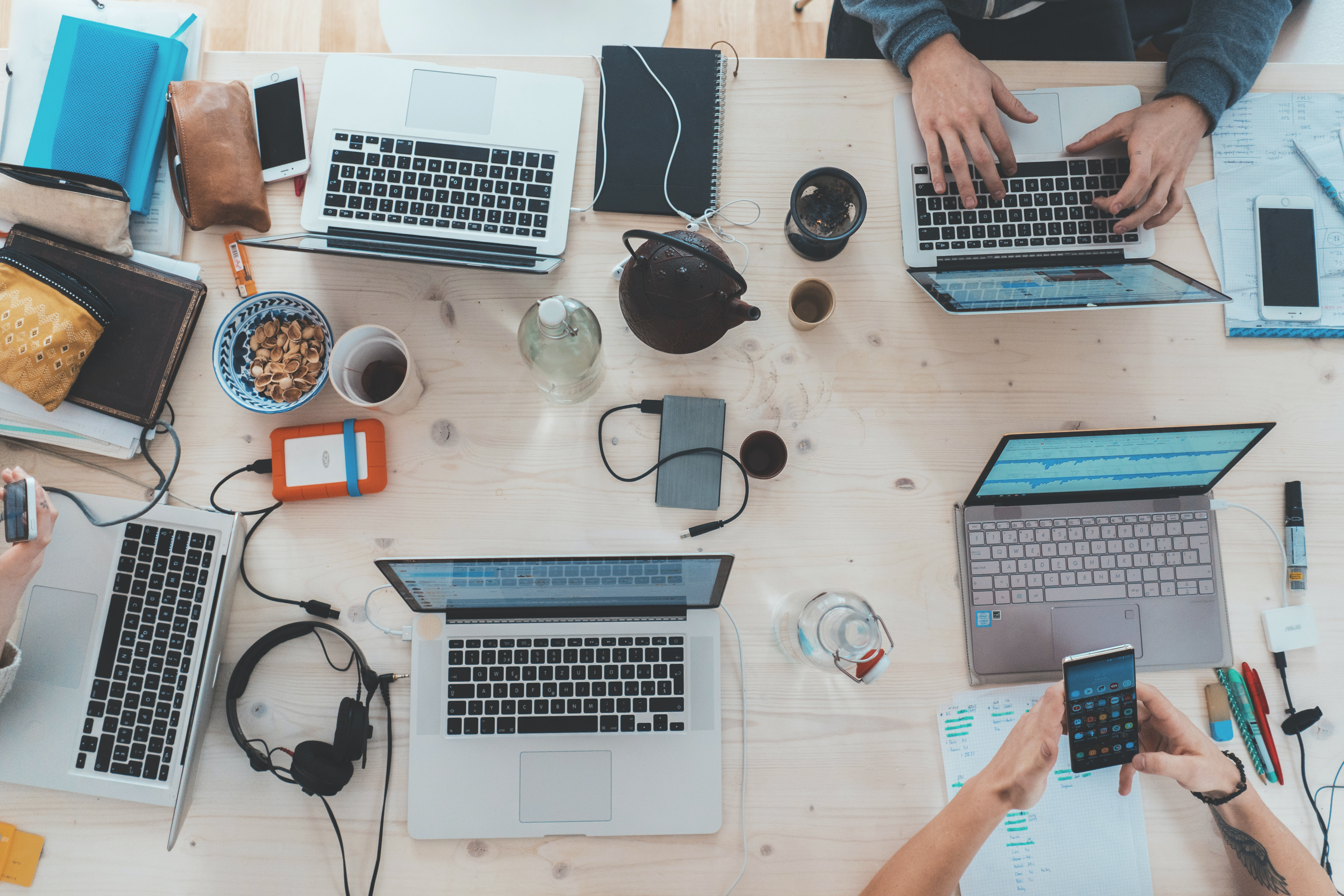 Work table with laptops and mugs